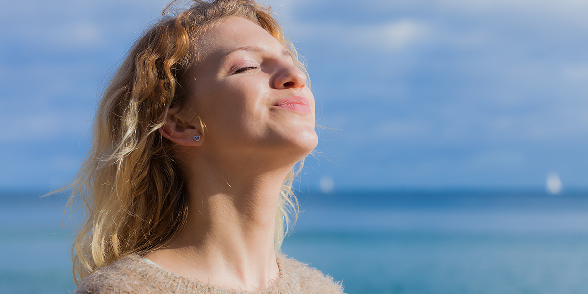 Woman with sun shining on her face
